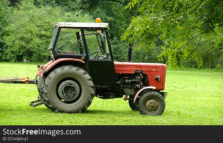 Tractor standing in the park. Tractor standing in the park