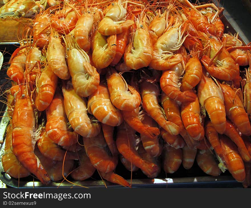 A big pile of cooked shrimps on a tray. A big pile of cooked shrimps on a tray