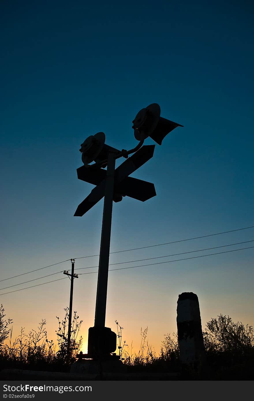 Silhouette of a railway stop sign at summer sunset. Silhouette of a railway stop sign at summer sunset