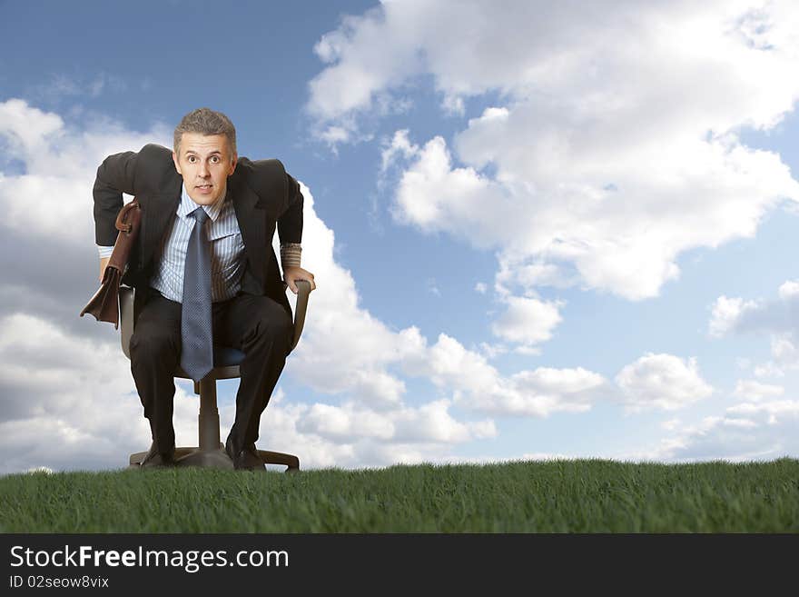 The businessman goes in an armchair across the field