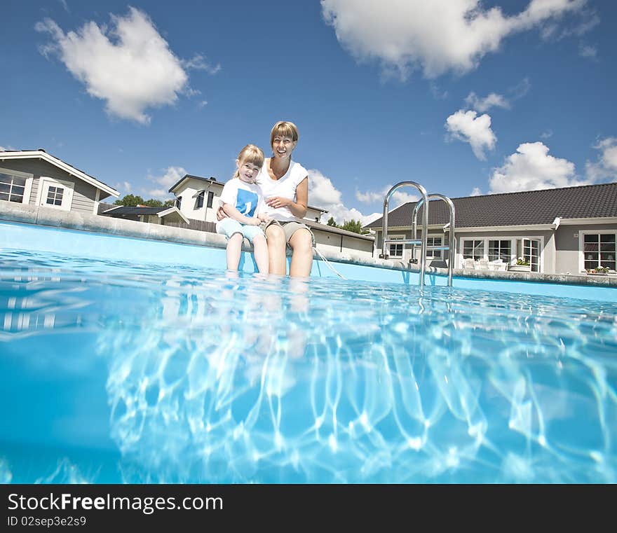 Mother and daughter at the swiiming pool