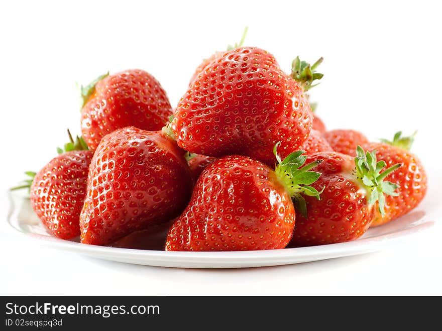 Strawberries on white plate with white background