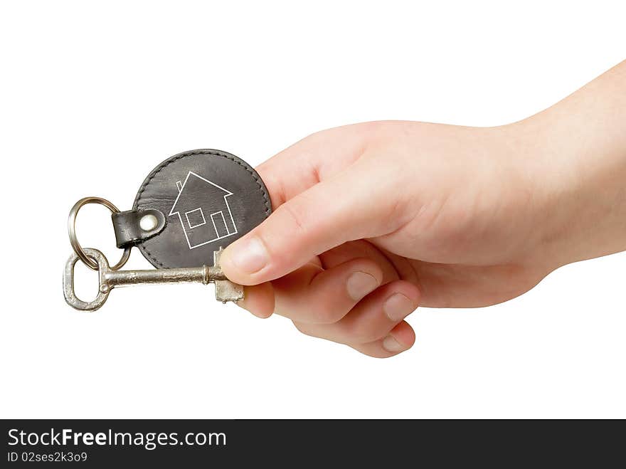 Retro key trinket in human hand isolated with clipping path. Retro key trinket in human hand isolated with clipping path