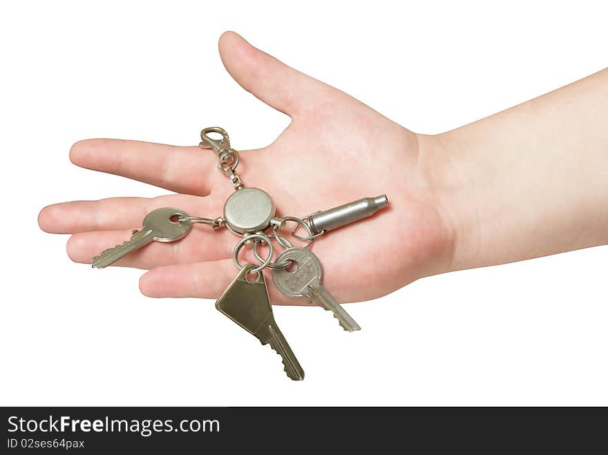 Key trinket in human hand isolated with clipping path