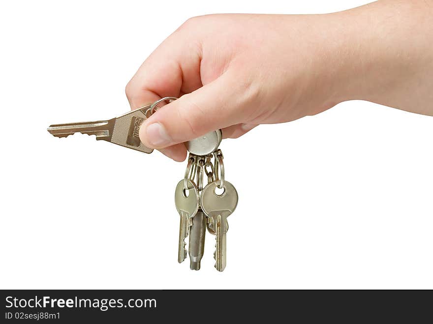 Key trinket in human hand isolated with clipping path