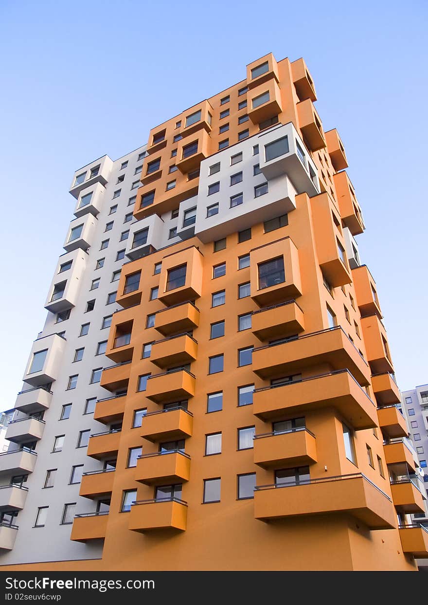 A tall modern multistory apartment block. A tall modern multistory apartment block