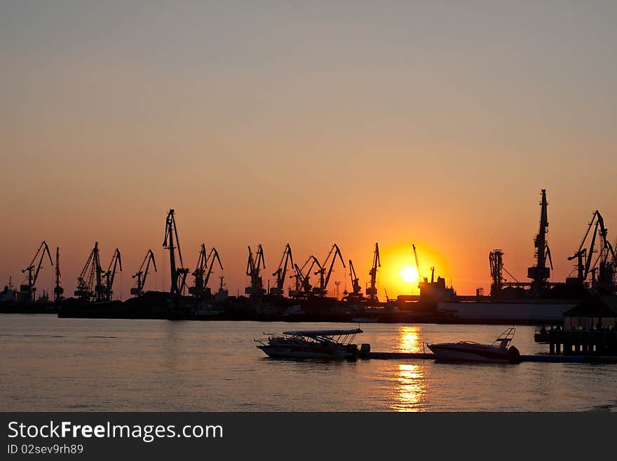 Seaport with the tower cranes at sunset