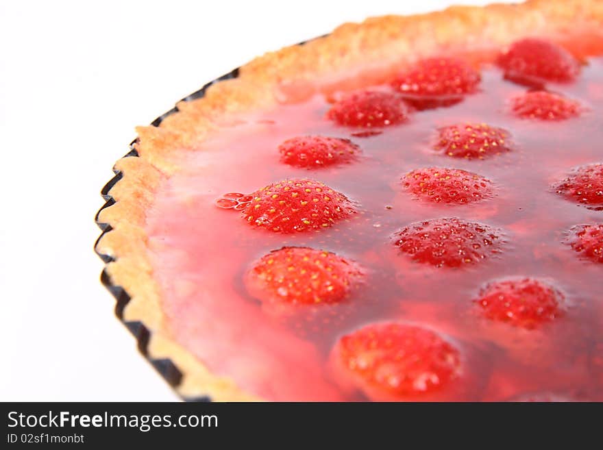 Strawberry Tart in a tart pan on a white background in close up