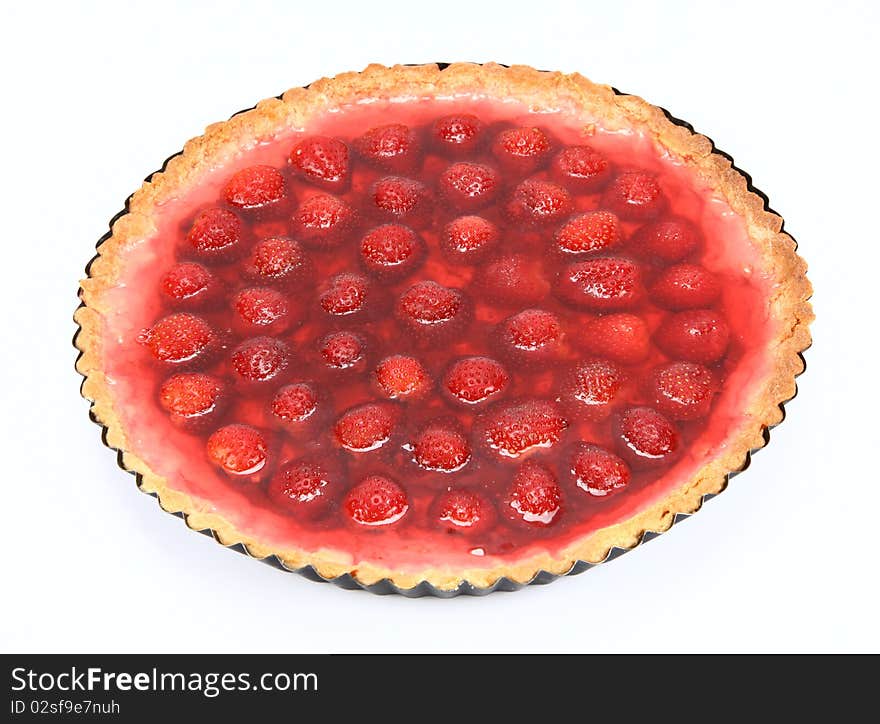 Strawberry Tart in a tart pan on a white background