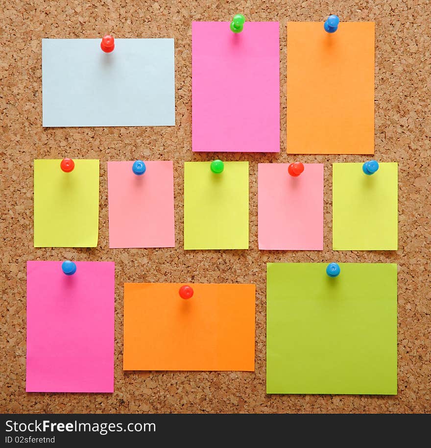 Sticky notes over brown cork background