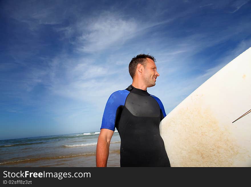 Man holding surfboard at the beach. Man holding surfboard at the beach