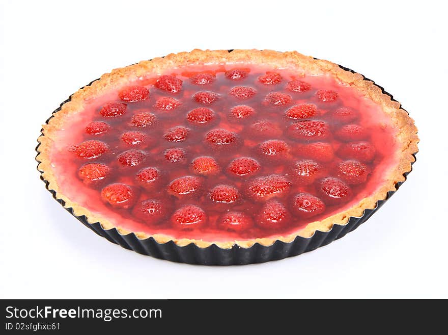 Strawberry Tart in a tart pan on a white background