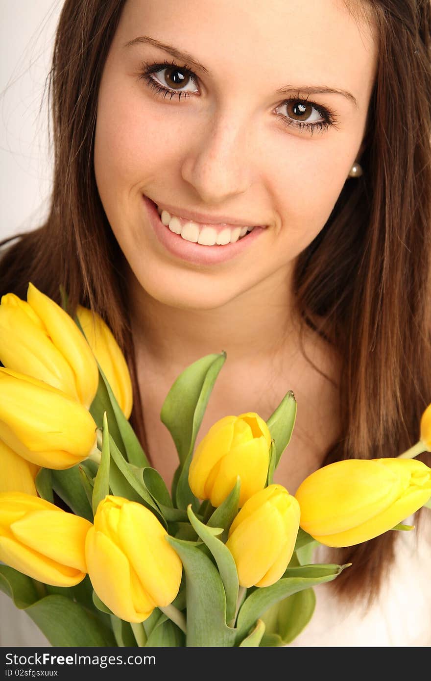 Young brunette woman with yellow flowers. Young brunette woman with yellow flowers