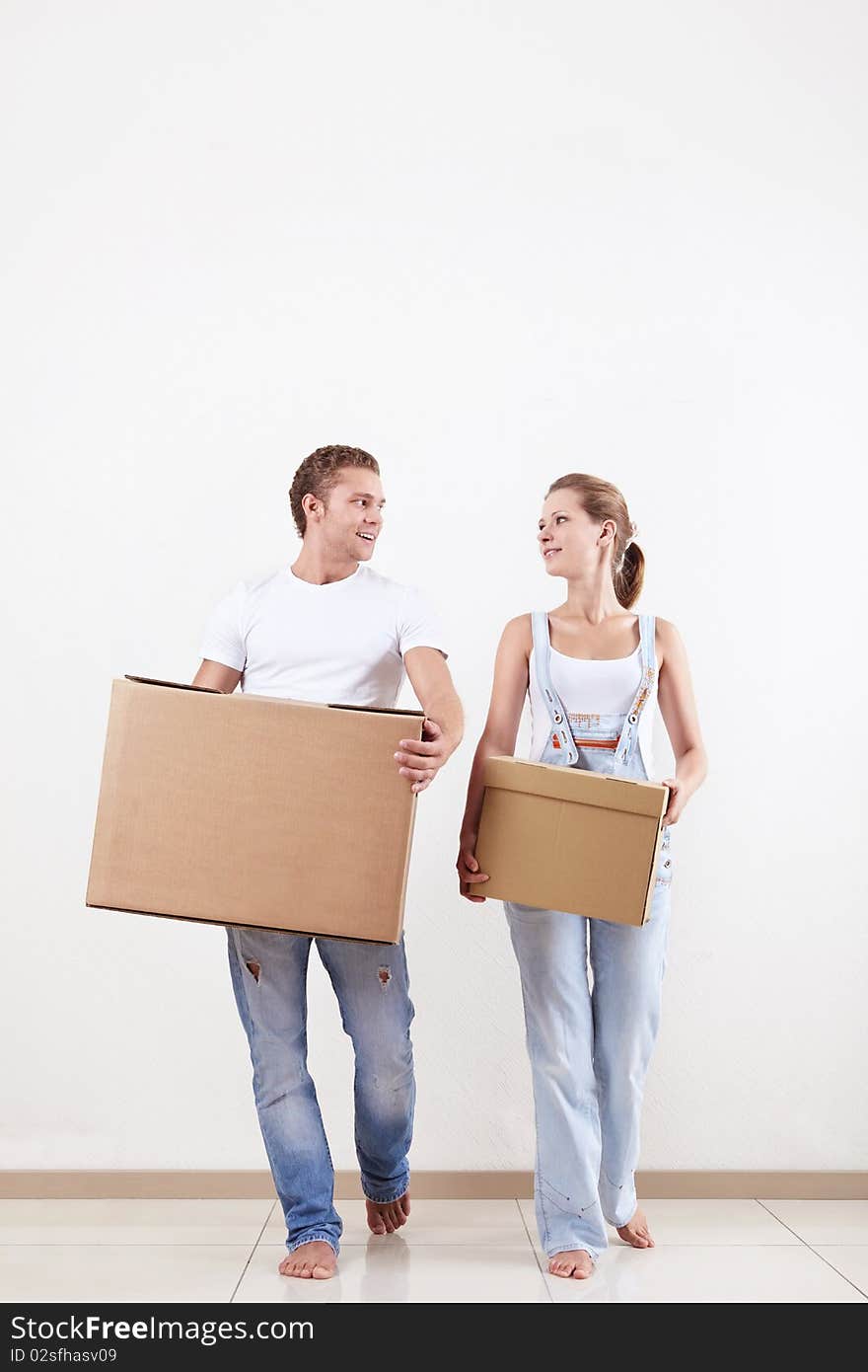 Attractive couple moves cardboard boxes in new home