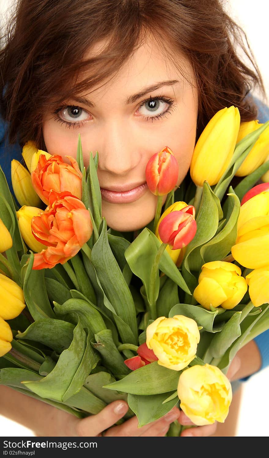 Young brunette woman with yellow and red flowers. Young brunette woman with yellow and red flowers