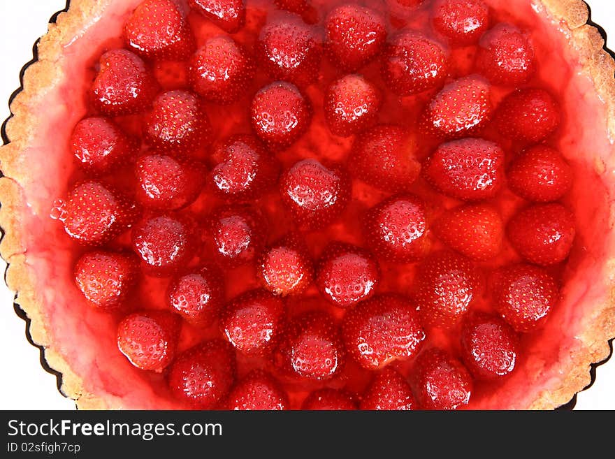 Strawberry Tart in a tart pan in close up on a white background