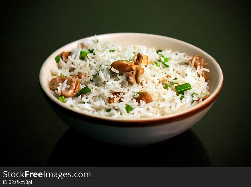 Risotto with mushrooms for meal over black background made from rice. Risotto with mushrooms for meal over black background made from rice