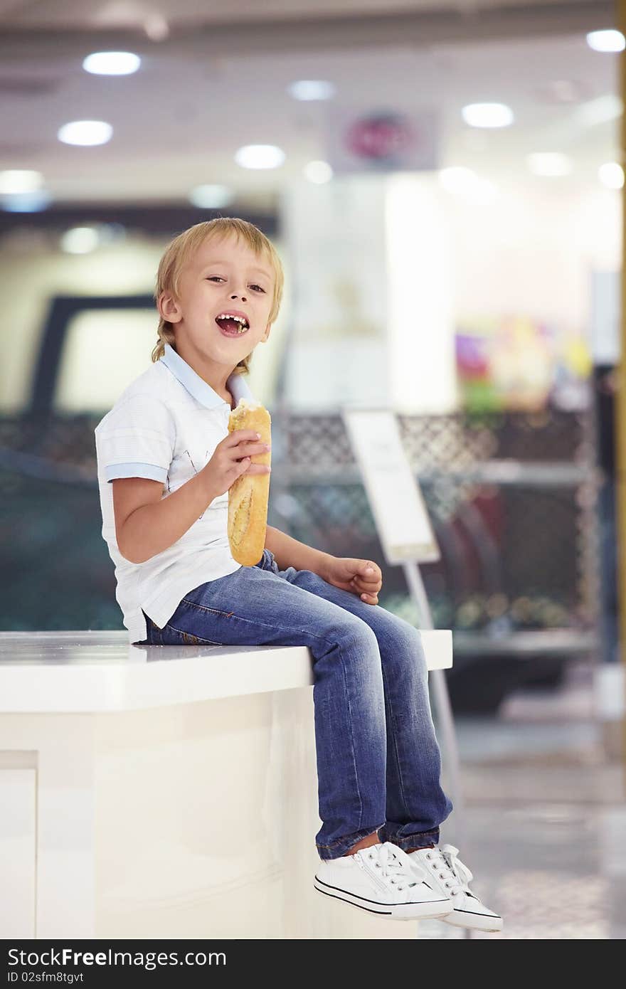 Little boy eating a baguette. Little boy eating a baguette