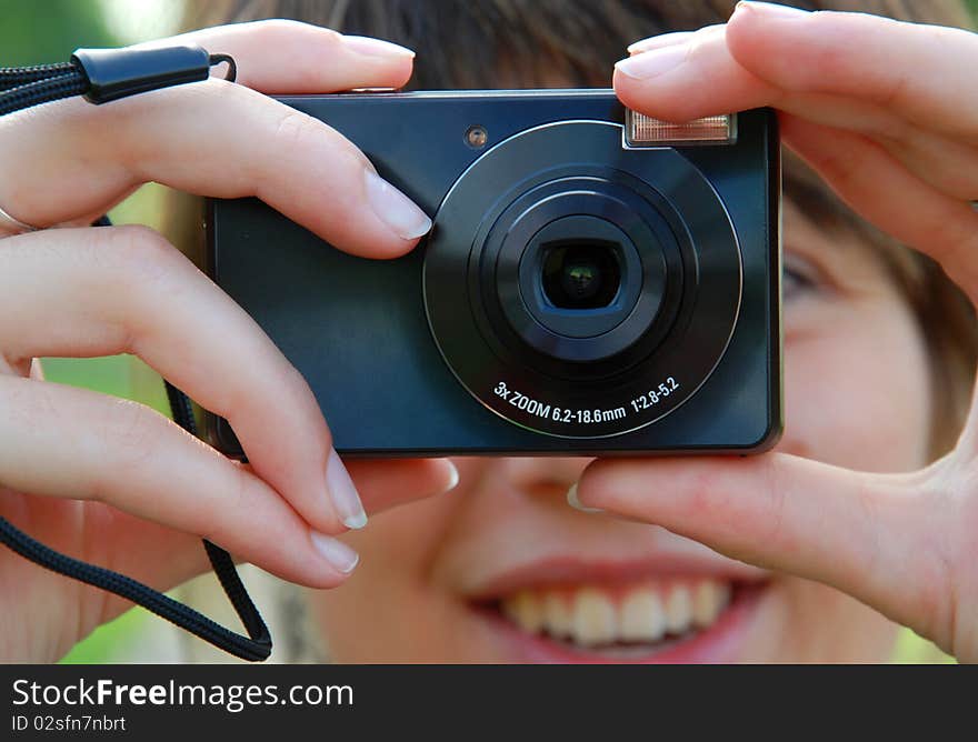 Smiling girl is holding the camera