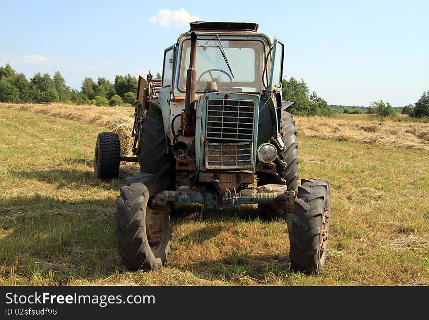 Old russian tractor in the field. Old russian tractor in the field.