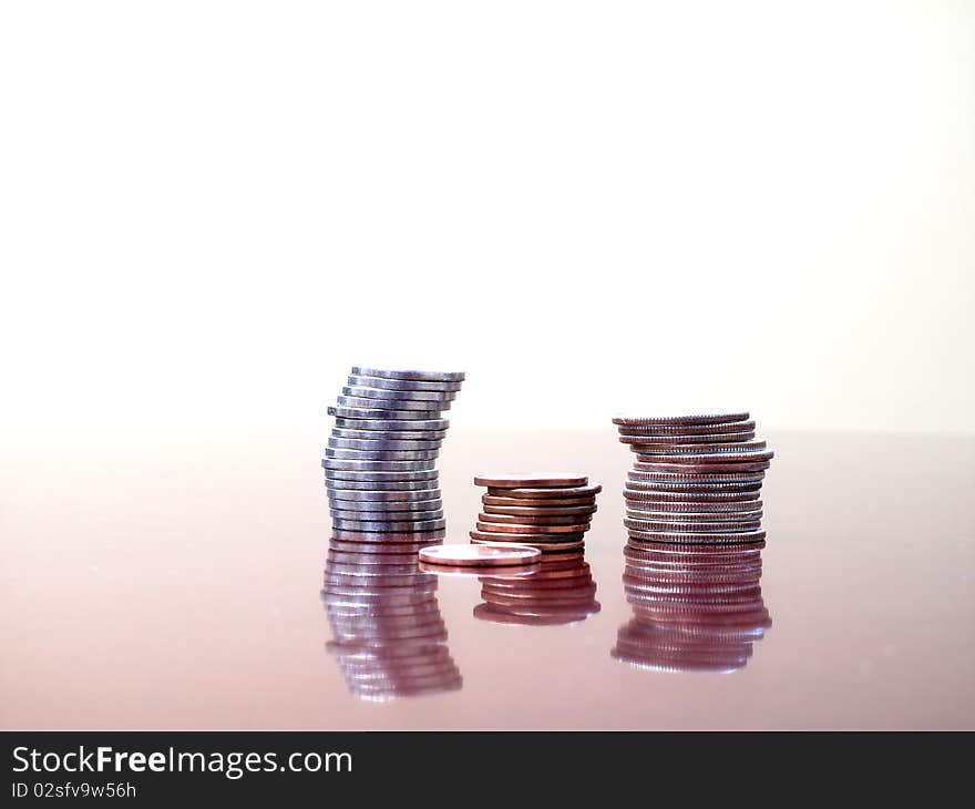 Stack of coins on desktop with white background