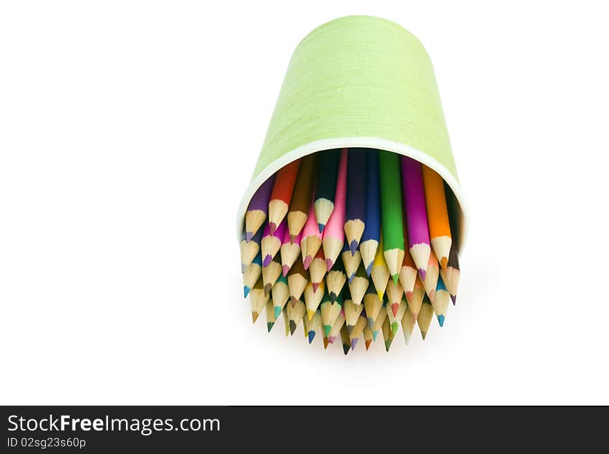 Isolated color pencils are in the glass on a white backround