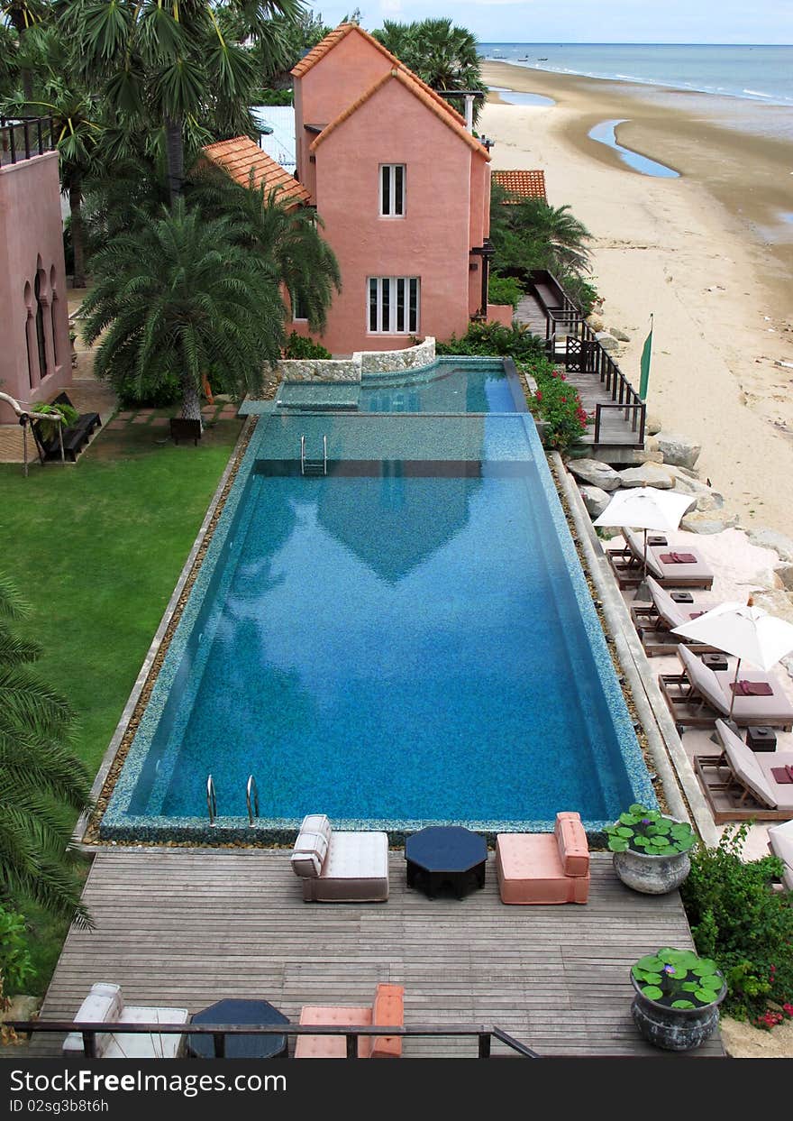 View of a hotel swimming pool near the beach from the top. View of a hotel swimming pool near the beach from the top