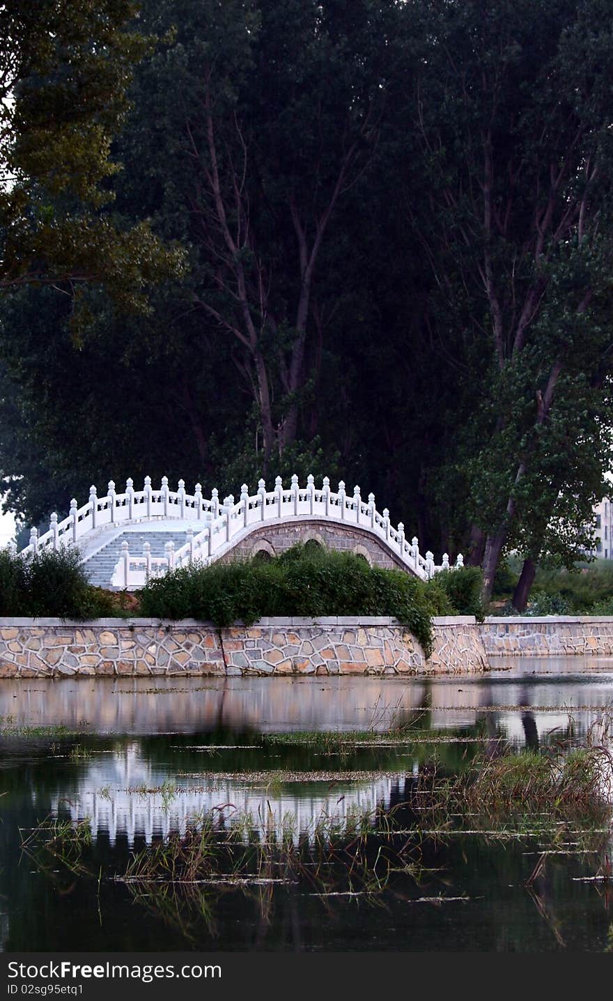 chinese-style stone bridge in the park. chinese-style stone bridge in the park.