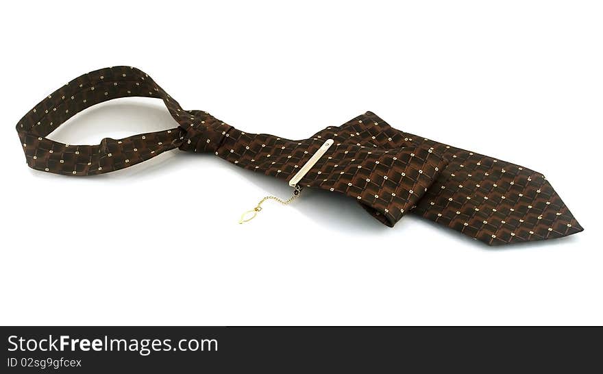 Tie with a gold pin on a white background