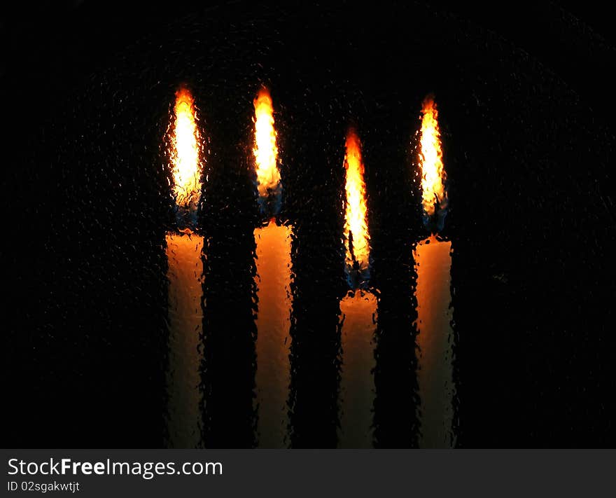 Candle light behind frosted glass