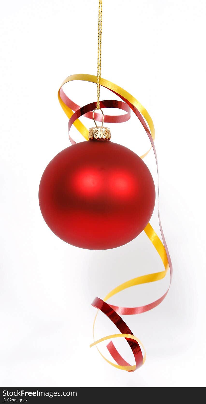 Hanging red glass ball with the ribbons on the white background