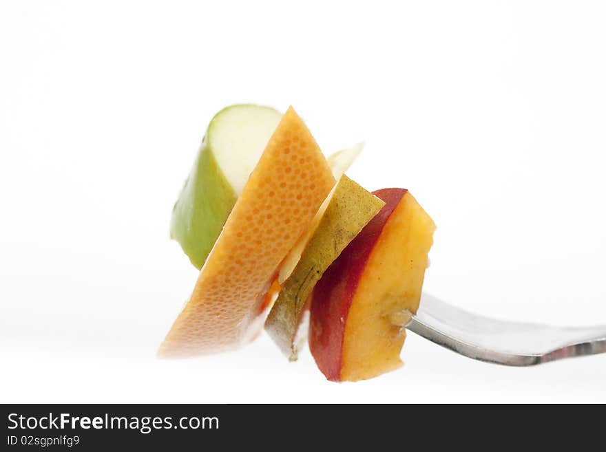 Fruit on a fork isolated on a white background