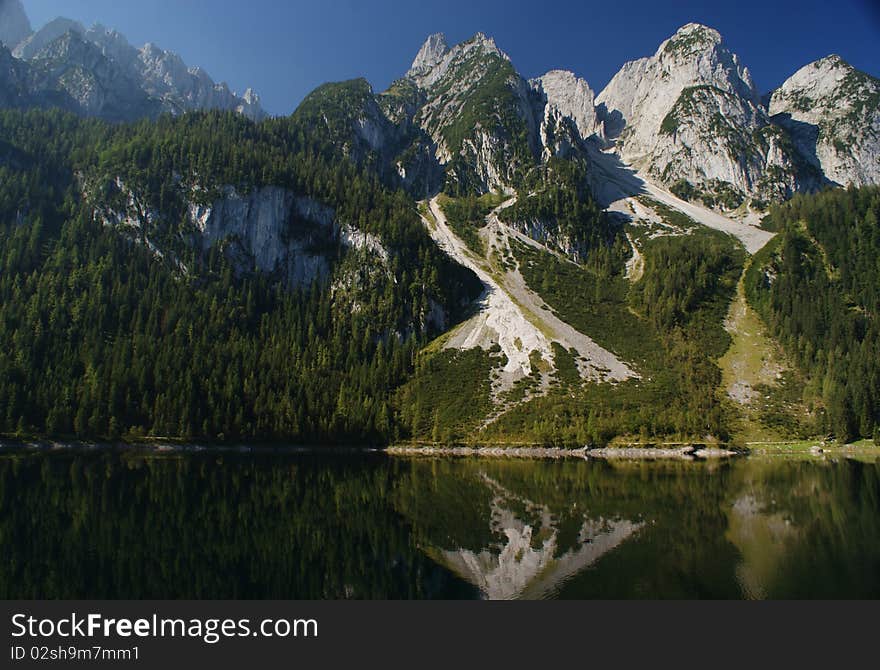 Mountain reflection under the sun