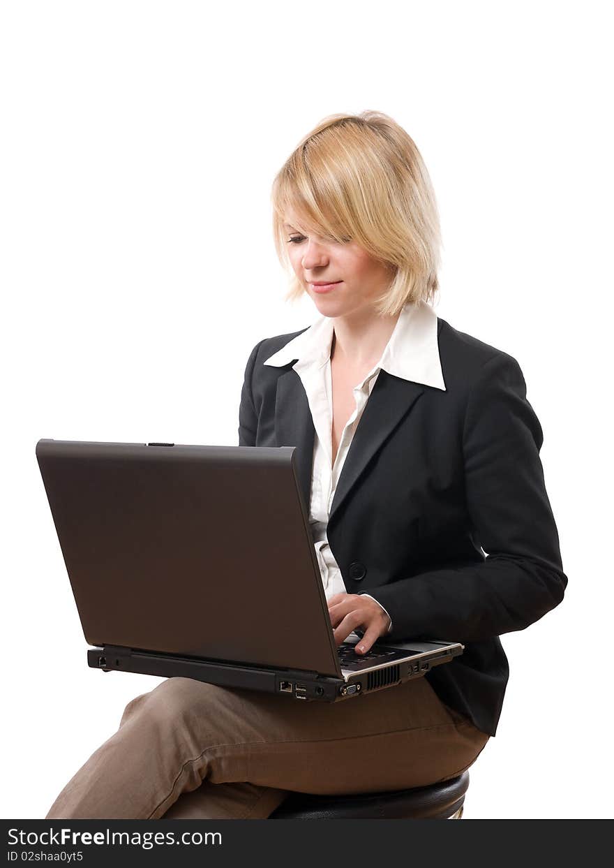 Young concentrated businesswoman typing on laptop. Young concentrated businesswoman typing on laptop