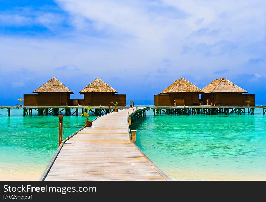 Water bungalows at a tropical island - travel background