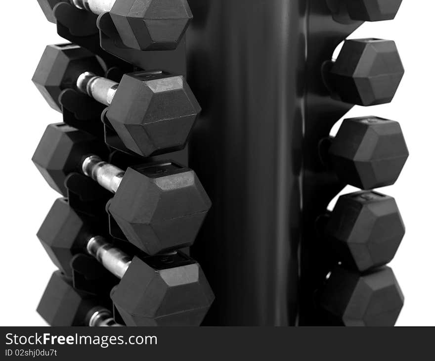 A dumbell rack with dumbells isolated against a white background