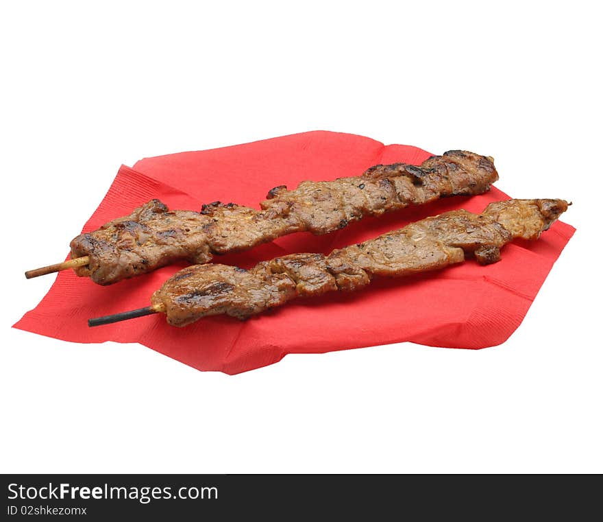 Pork strips on a stick on white