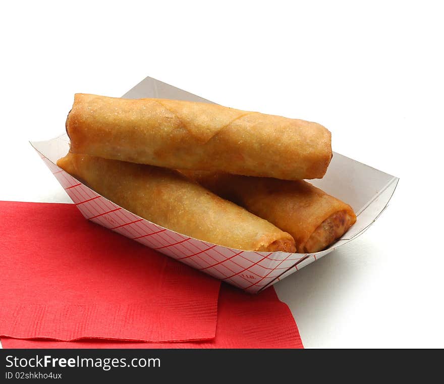 Three eggrolls on red napkin 
on white background