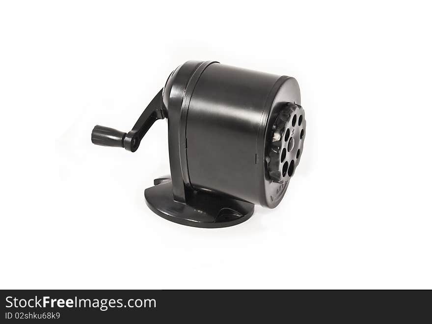 A back metal manual pencil sharpener isolated on a white background. A back metal manual pencil sharpener isolated on a white background.