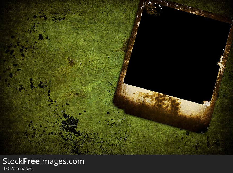 A isolated grunge burned photo on a green wall. A isolated grunge burned photo on a green wall