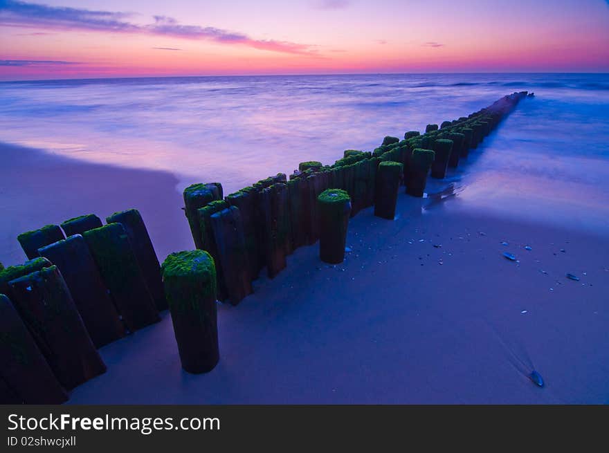 Pilings going into ocean at dawn. Pilings going into ocean at dawn