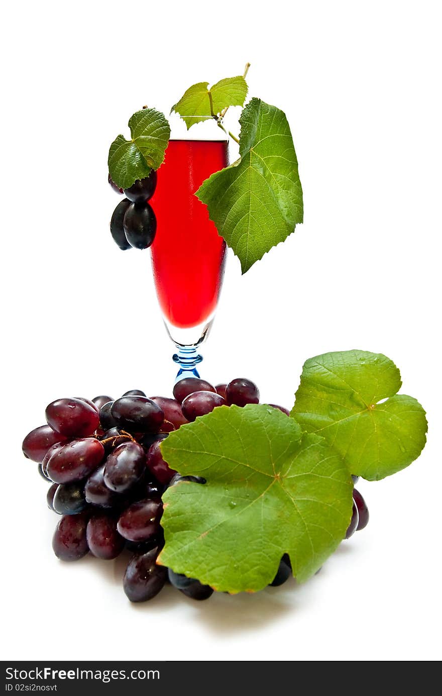 Red wine in glass with plump grapes. Isolated on white. Soft shadow. Red wine in glass with plump grapes. Isolated on white. Soft shadow