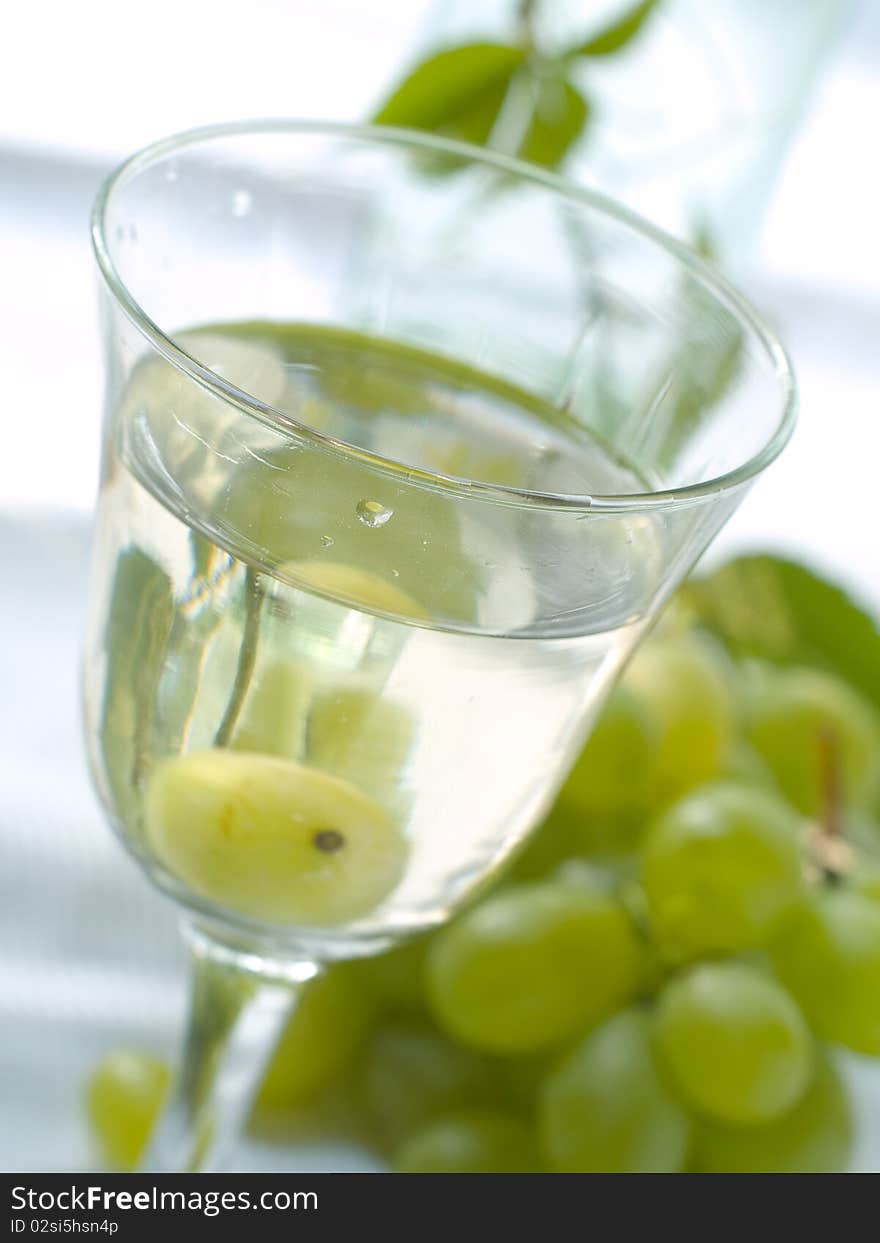 White wine and grape in glass outside close up shoot