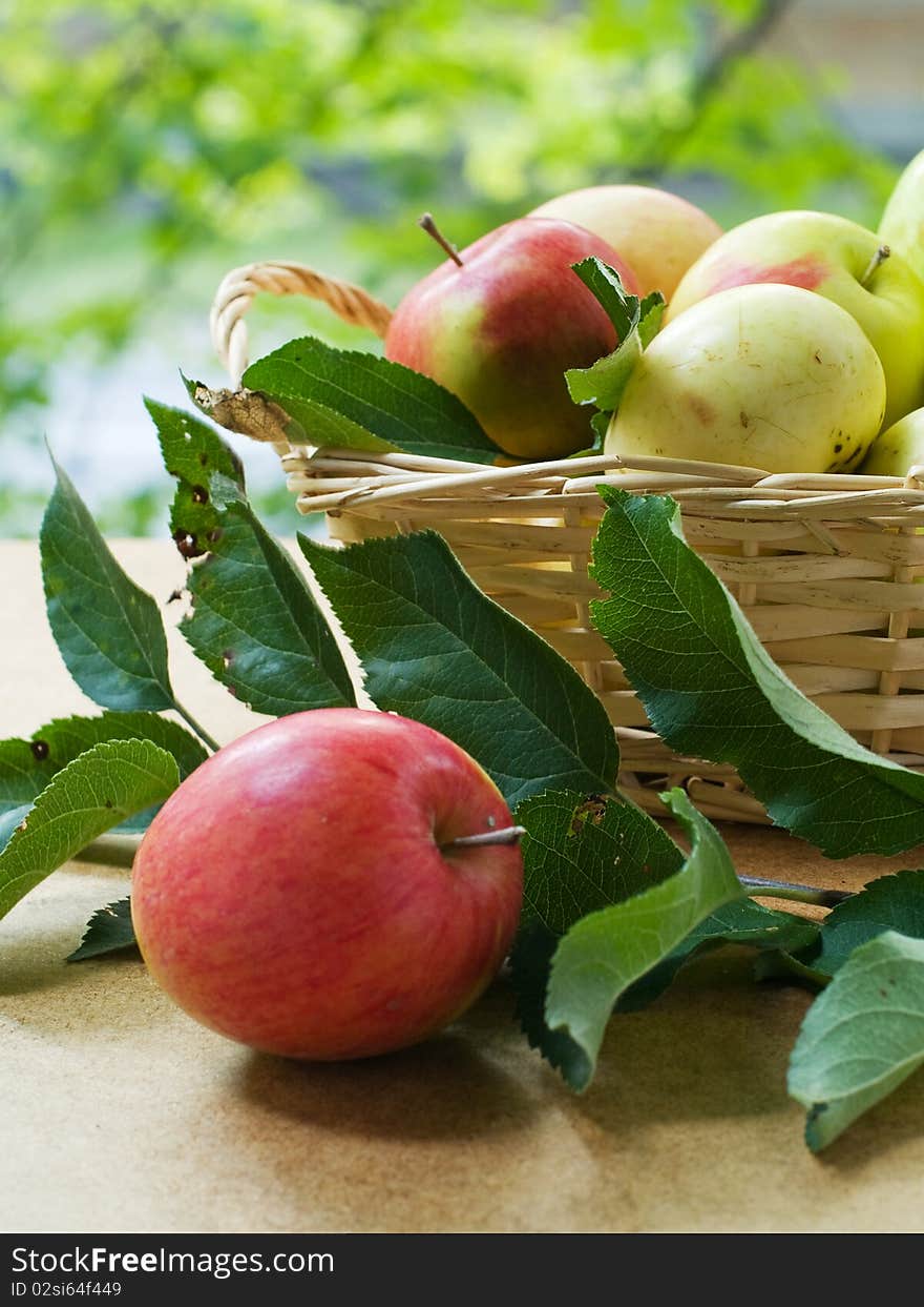 Fresh ripe apples in basket  on table