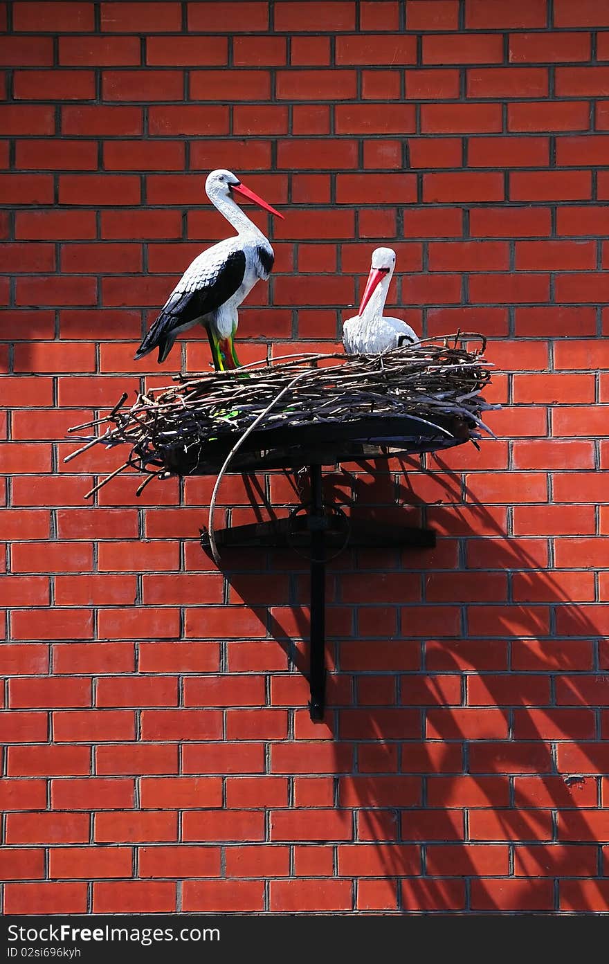 Nest of storks on a brick house wall. Nest of storks on a brick house wall