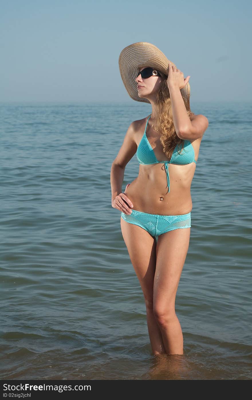 Young fashion woman in swimwear on the beach