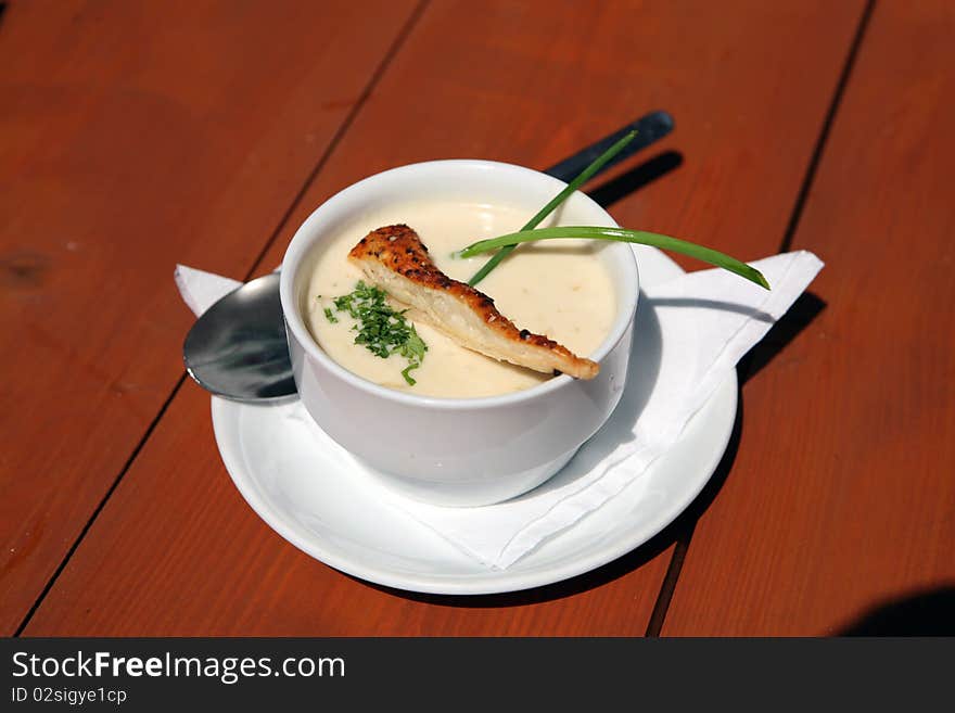 Traditional home made soup called Kyselica in bowl on wooden table from Walachia. Traditional home made soup called Kyselica in bowl on wooden table from Walachia