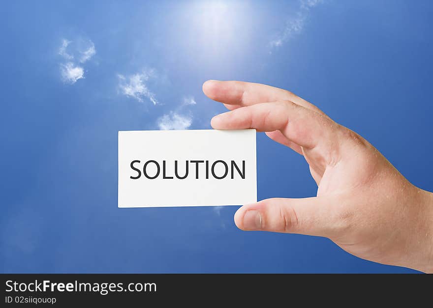 Solution text on white card in human hand