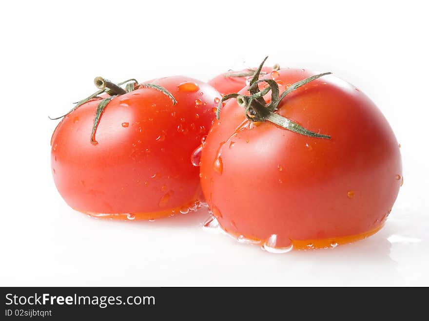 Three ripe tomatoes in water