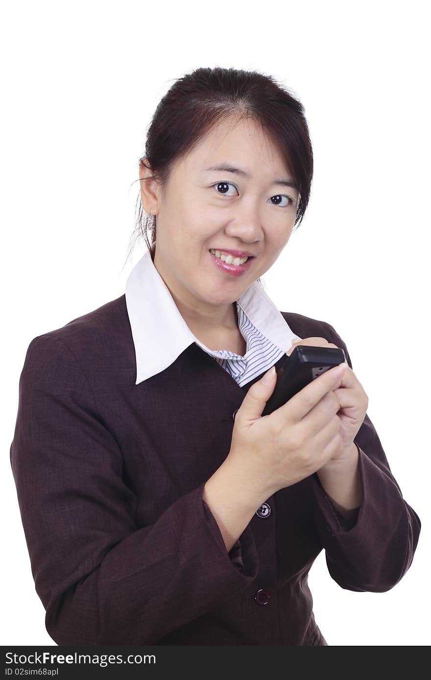 An Asian businesswoman texting on a smartphone with a stylus. An Asian businesswoman texting on a smartphone with a stylus.